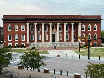 Historic campus building viewed across a plaza